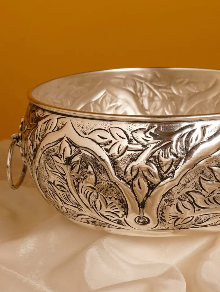 Close view of the etched floral work and a ring handle