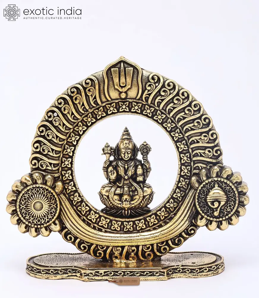 Brass Lakshmi statue in a round carved frame