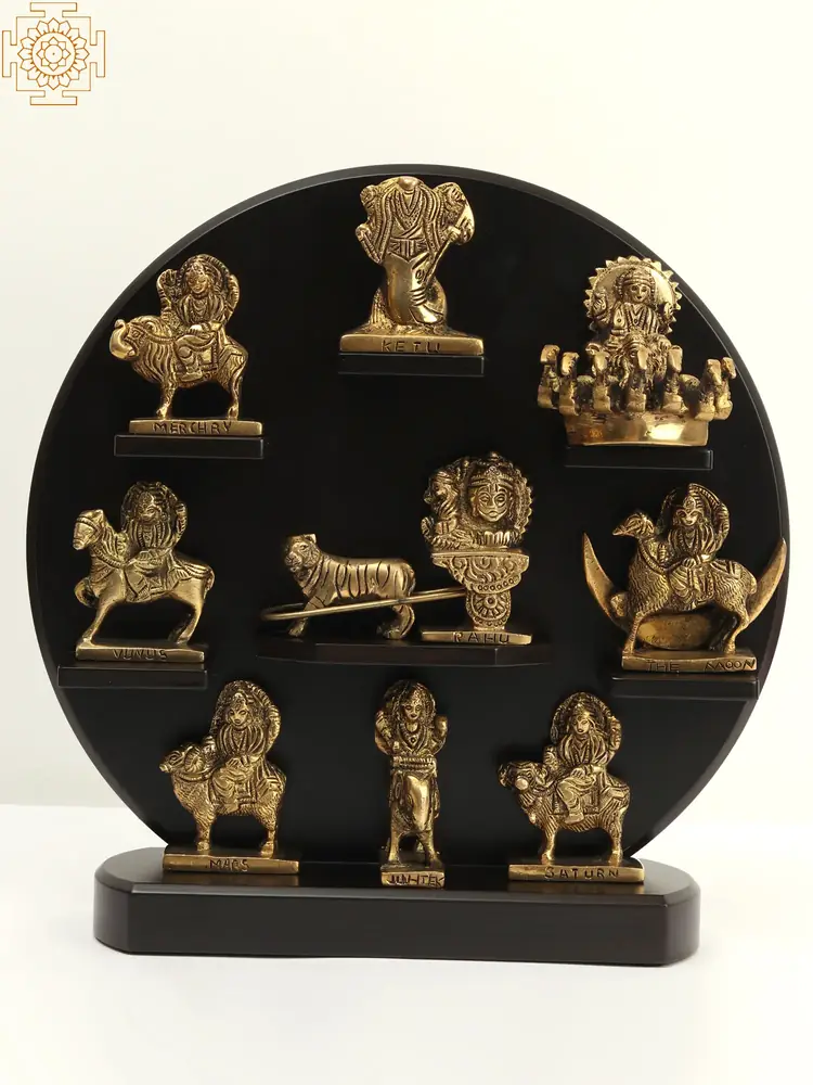 Nine brass planetary figures arranged on a black round stand