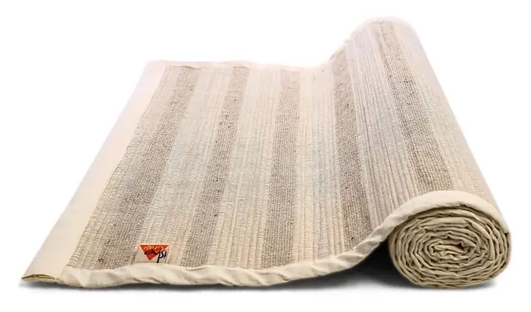 The mat partly unrolled on the floor