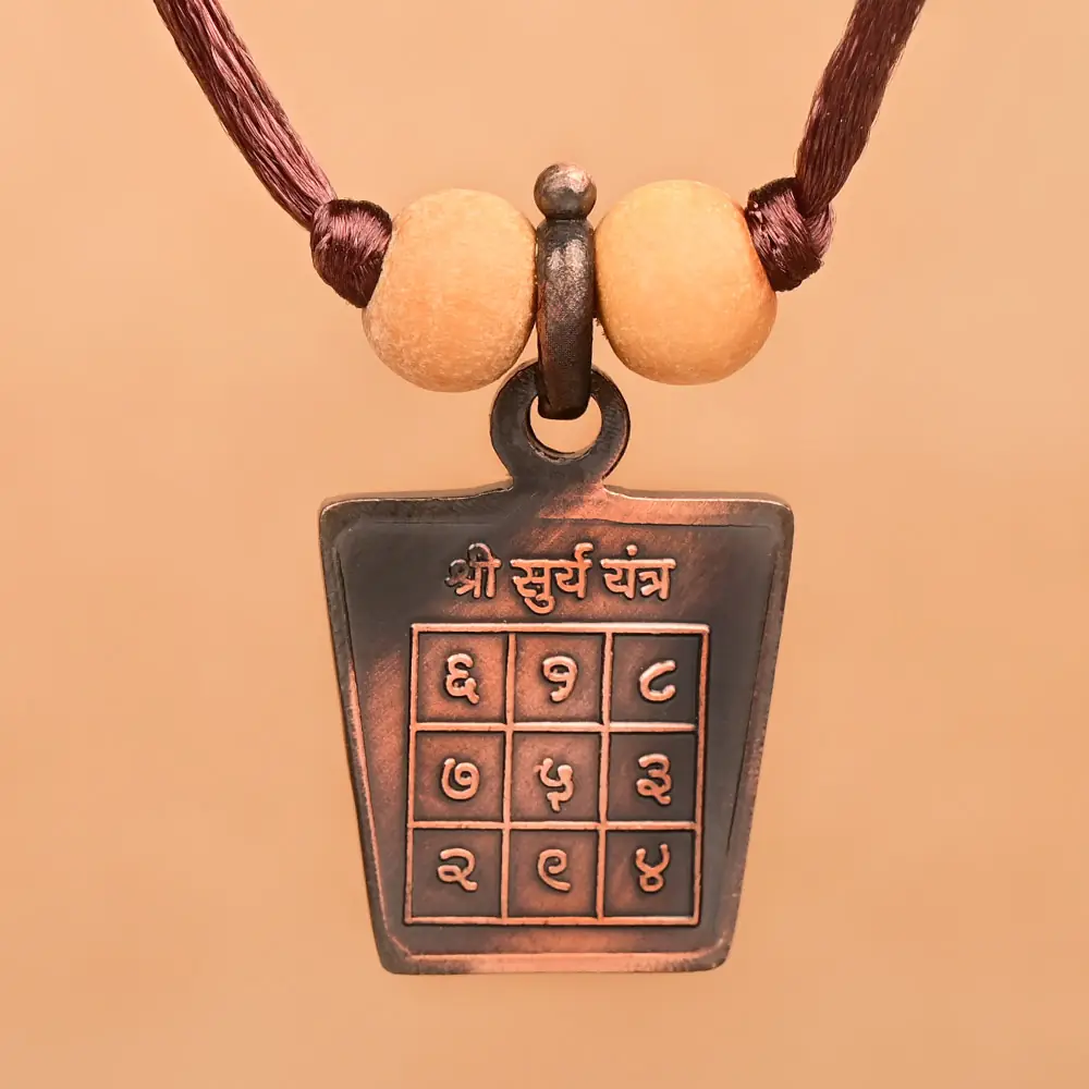Surya yantra side of the copper locket on a thread