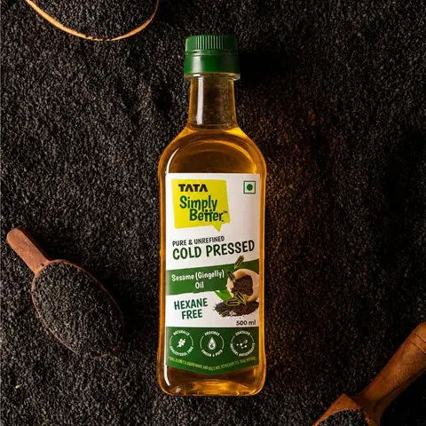 Bottle on a dark background with sesame seeds