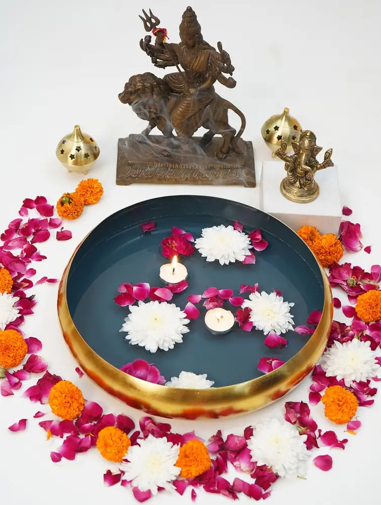 The urli filled with water, petals and floating lamps