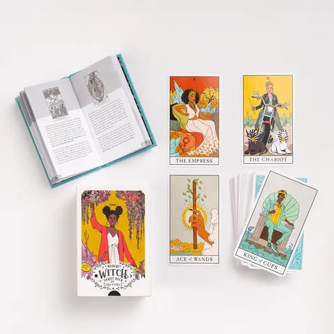 The guidebook open beside the box and a few cards
