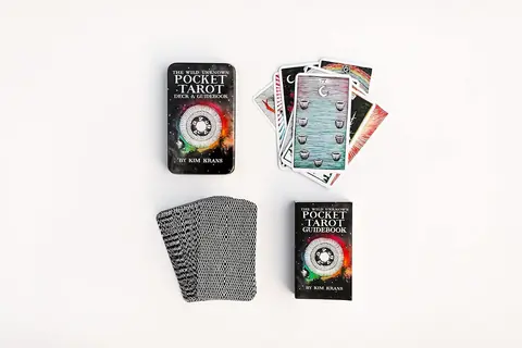 The tin with a stack of cards and a few cards face up