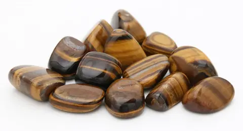 A heap of tumbled tiger's eye stones