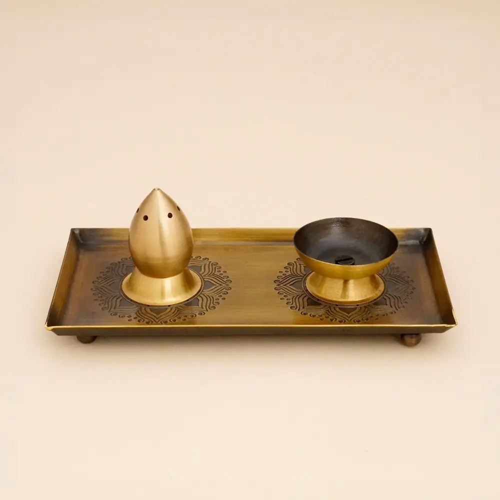 Small brass pooja set on a tray with a dome piece and a bowl