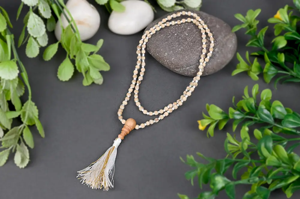 The mala in a loop with a tassel and stones