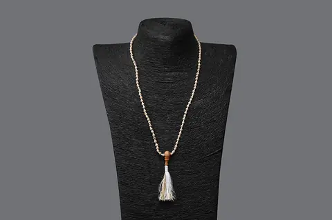 Tulsi mala on a dark display bust