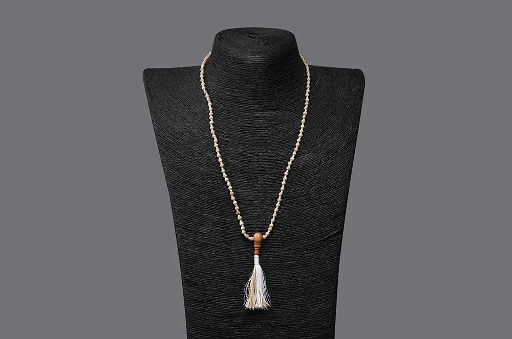 Tulsi mala on a dark display bust