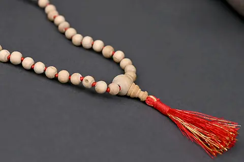 Close view of tulsi beads with a red tassel