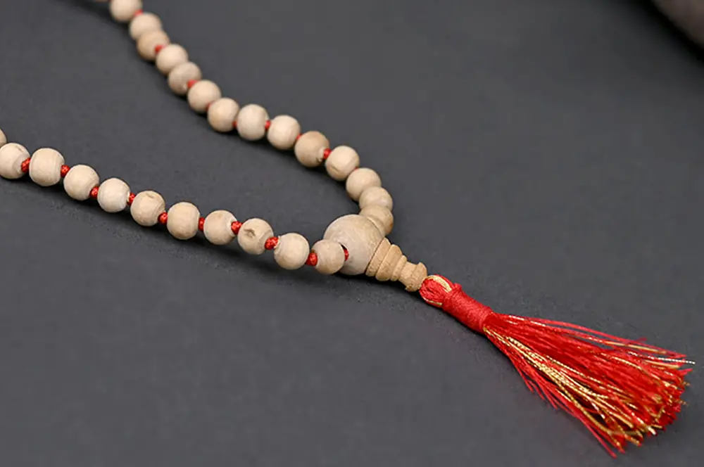Close view of tulsi beads with a red tassel