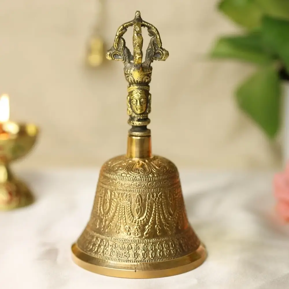 Brass hand bell with a vajra handle and carved body