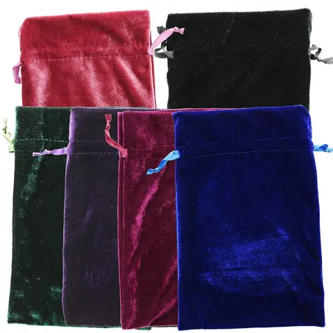 Velvet bags with ribbon drawstrings and loose stones beside them
