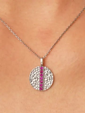 Close view of the round pendant with pink and clear stones