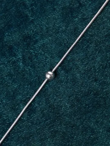 Close view of the fine chain and small bead