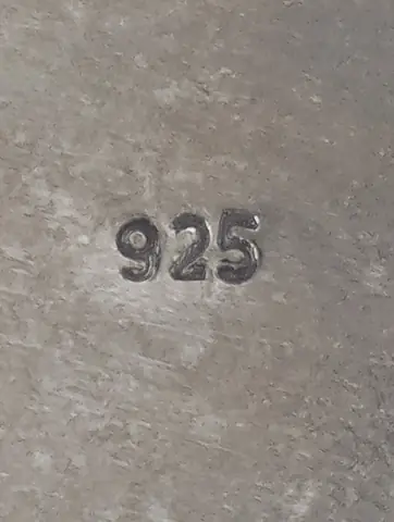 The 925 mark stamped on the silver